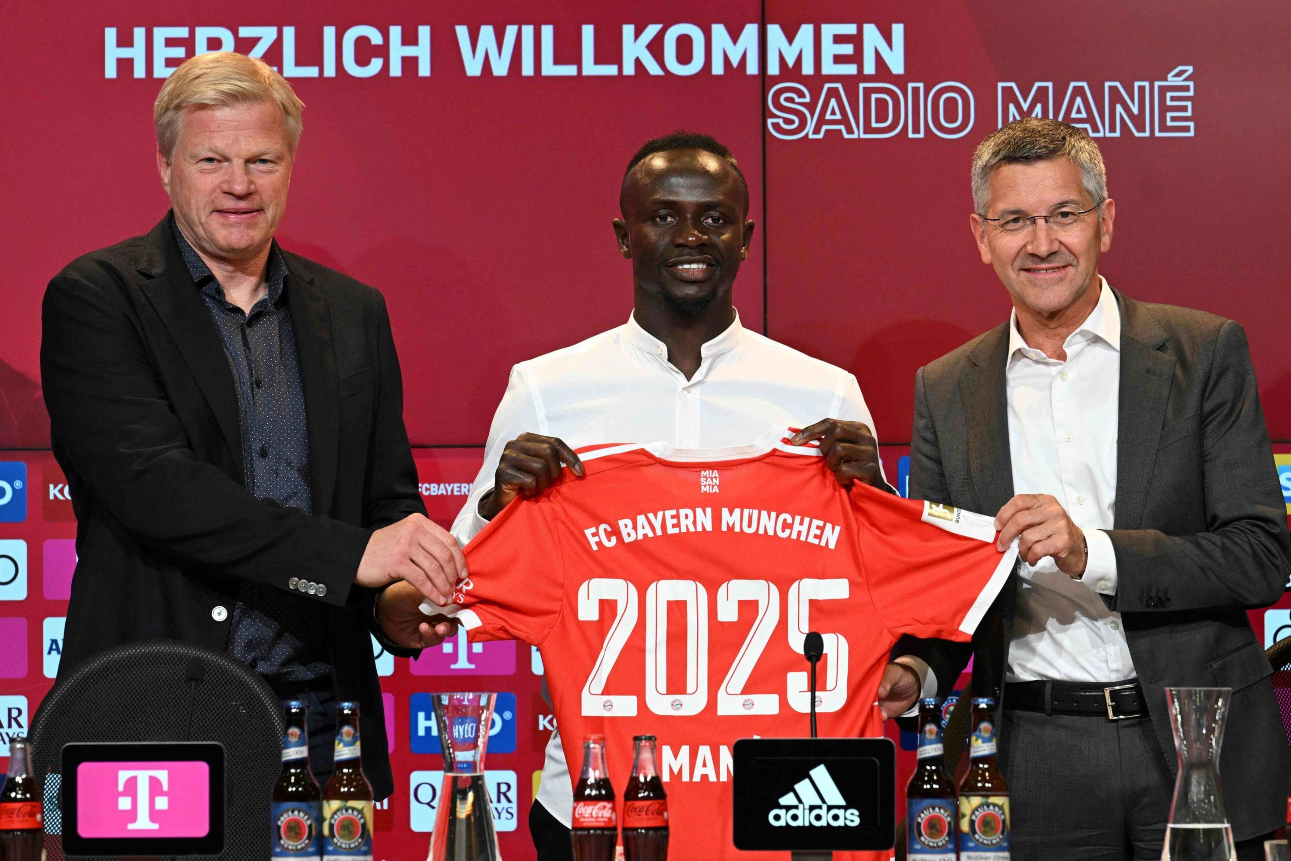 Bayern Munich's Senegalese new forward Sadio Mane (C) with his jersey poses next to Bayern Munich CEO Oliver Kahn (L) and President Herbert Hainer